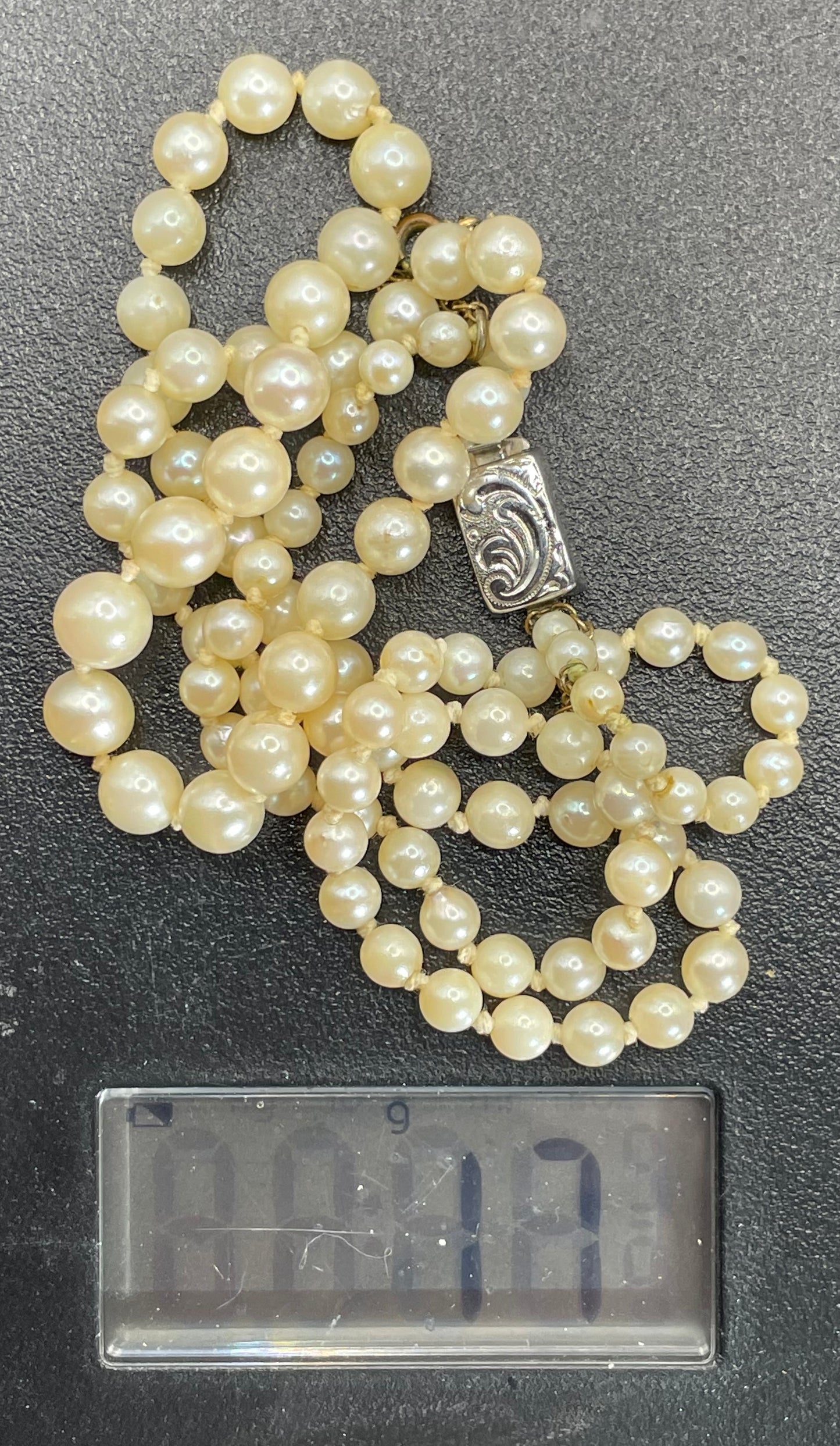 Vintage real cultured pearl necklace, graduated in size, hand-knotted, pretty engraved sterling silver clasp, mid-length