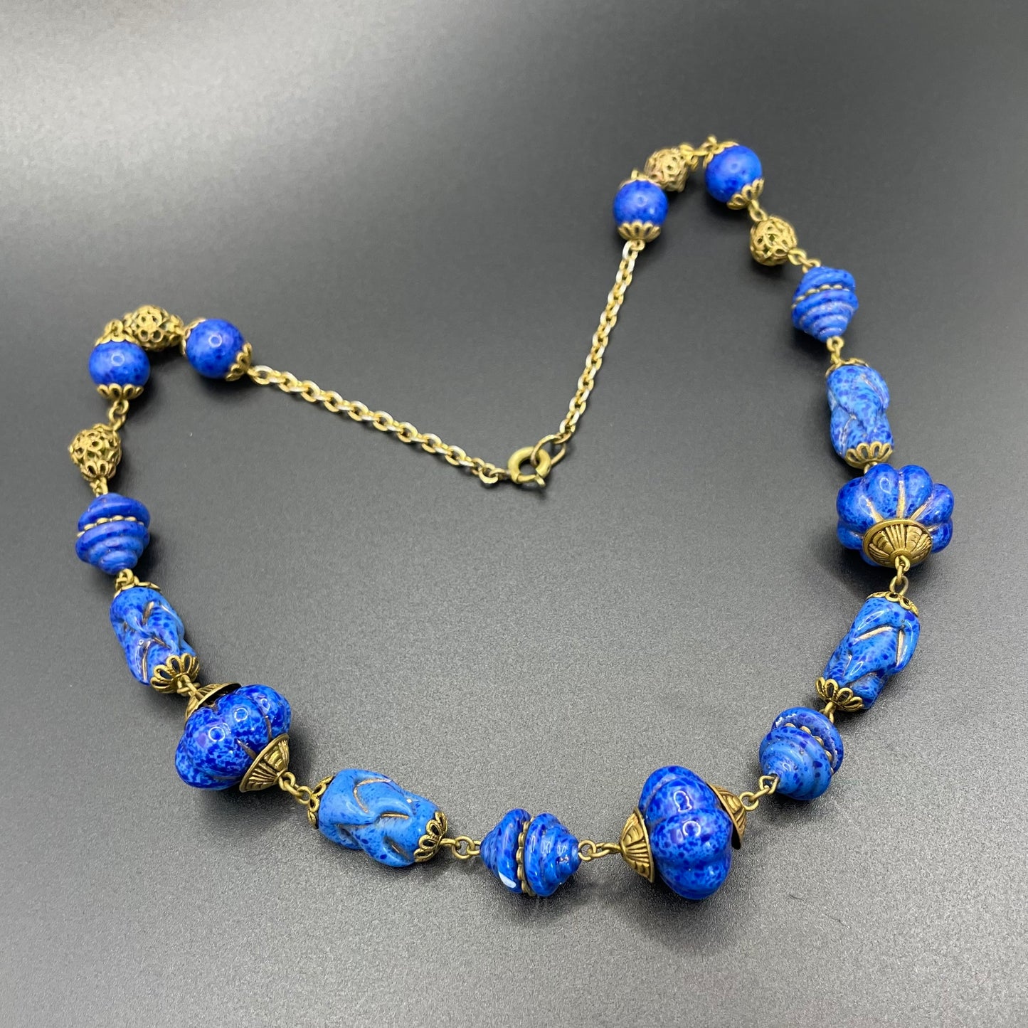 Vintage Art Deco Czech blue faux lapis lazuli glass bead necklace with beautiful moulded glass beads and gold tone filigree