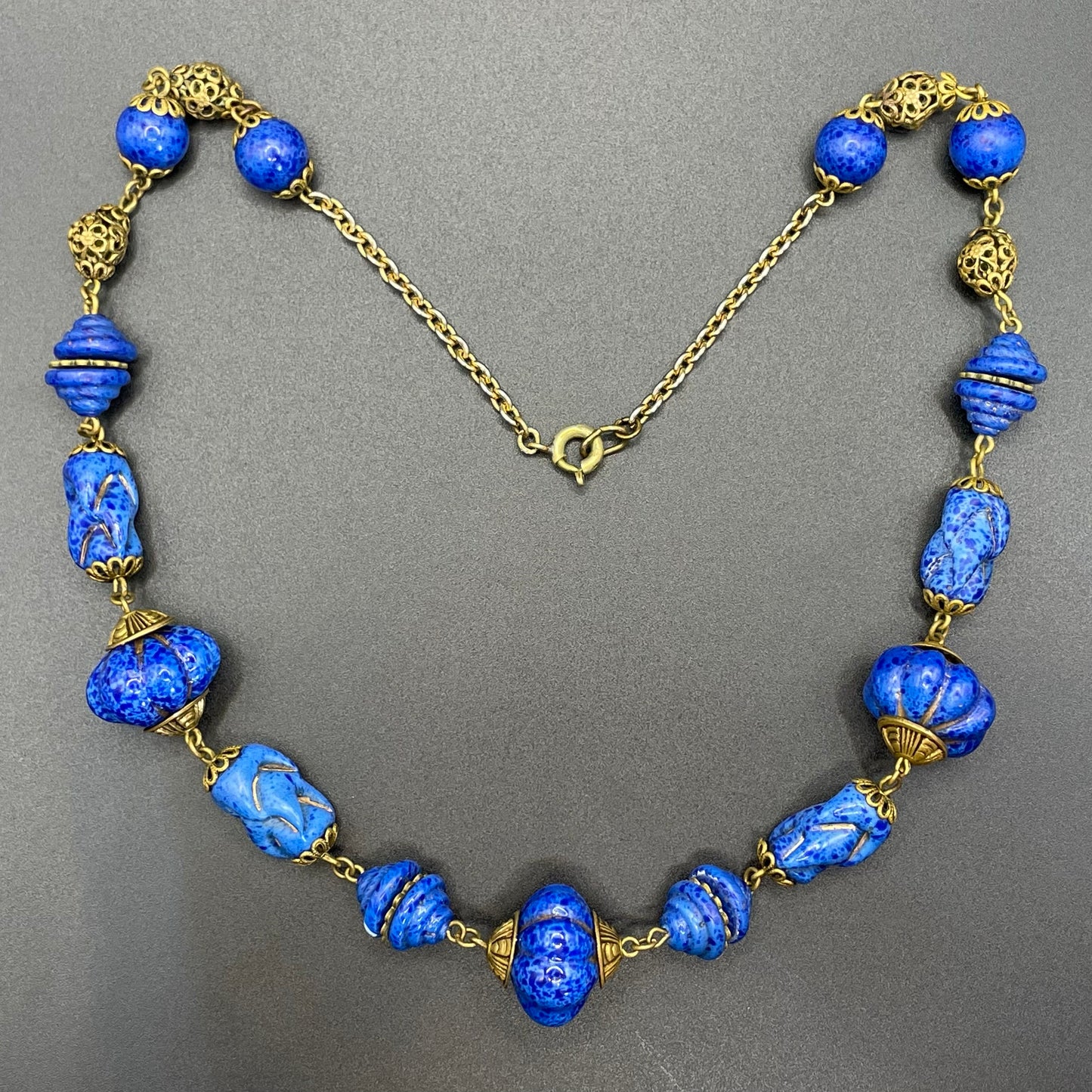 Vintage Art Deco Czech blue faux lapis lazuli glass bead necklace with beautiful moulded glass beads and gold tone filigree