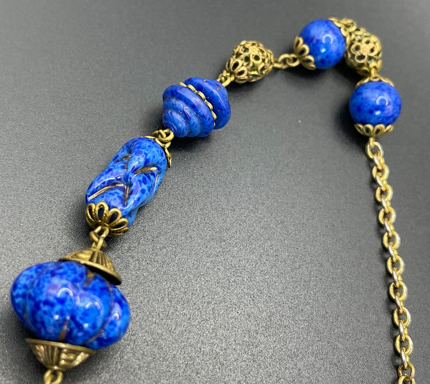 Vintage Art Deco Czech blue faux lapis lazuli glass bead necklace with beautiful moulded glass beads and gold tone filigree