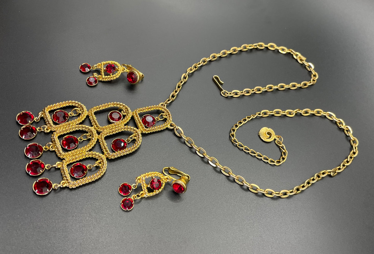 Vintage signed Lisner 1970s long gold tone and ruby red rhinestone chandelier pendant disco necklace and clip on earrings set