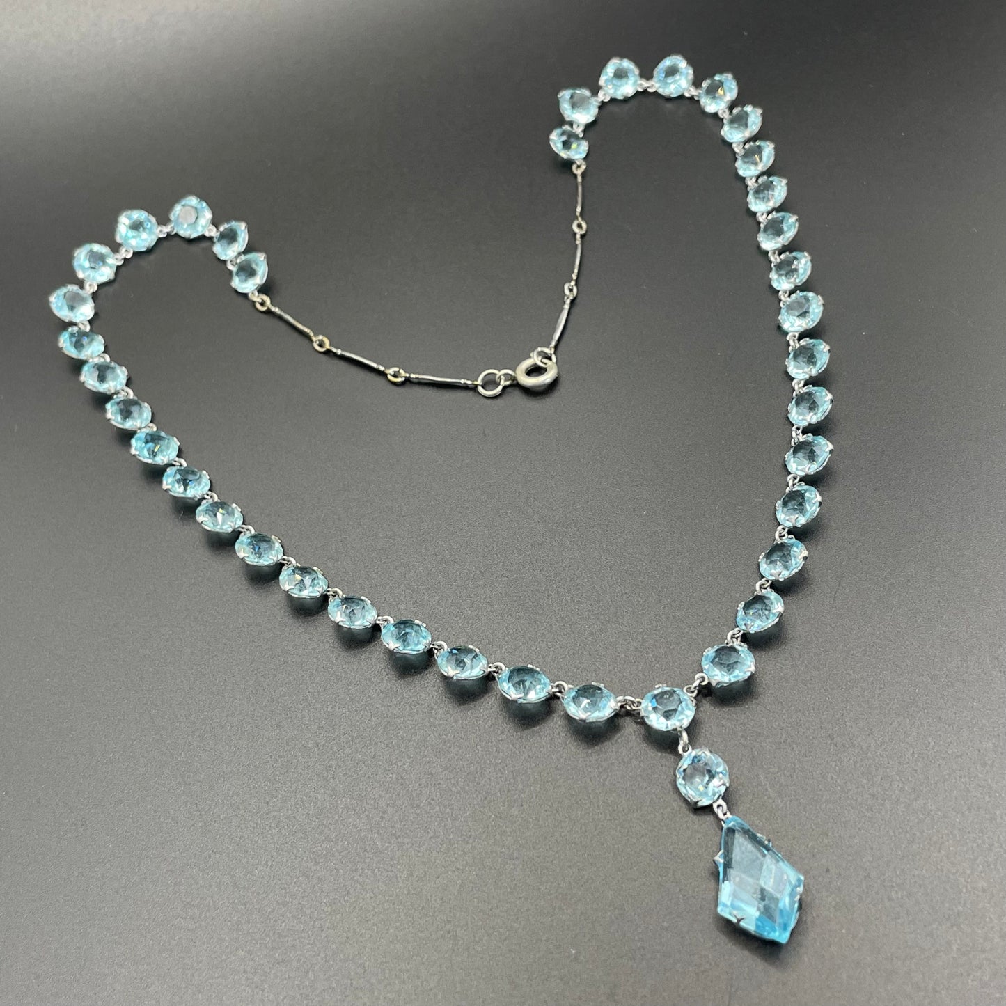 Vintage Art Deco light sapphire blue paste riviere necklace with crystal drop, bezel set open backed stones set in silver tone
