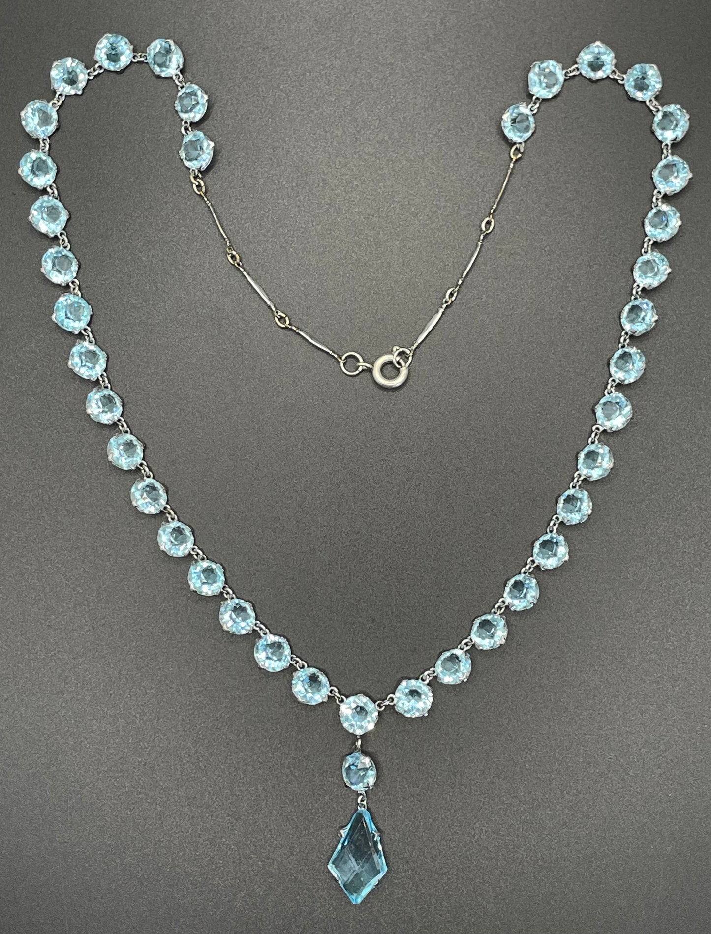 Vintage Art Deco light sapphire blue paste riviere necklace with crystal drop, bezel set open backed stones set in silver tone