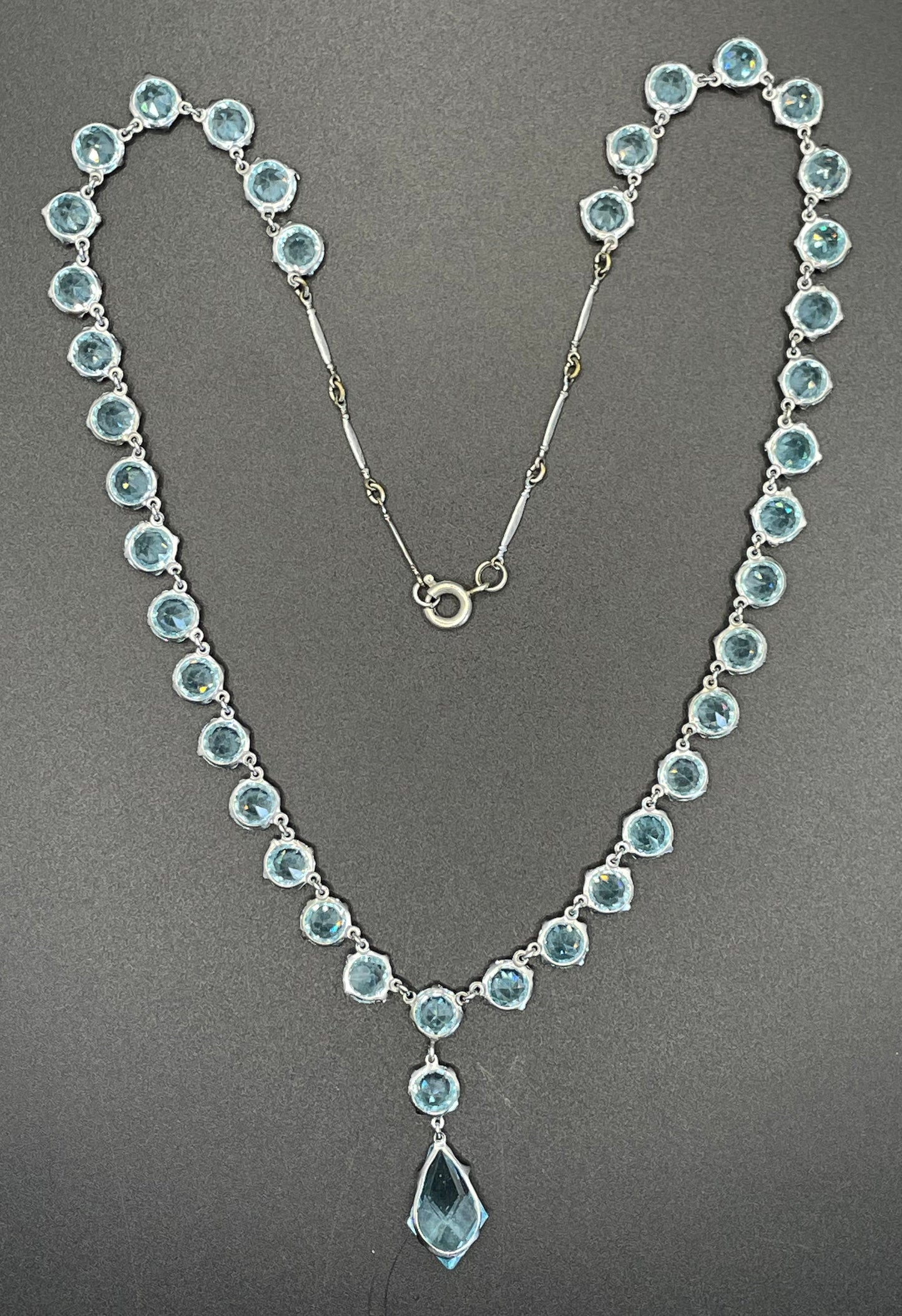Vintage Art Deco light sapphire blue paste riviere necklace with crystal drop, bezel set open backed stones set in silver tone