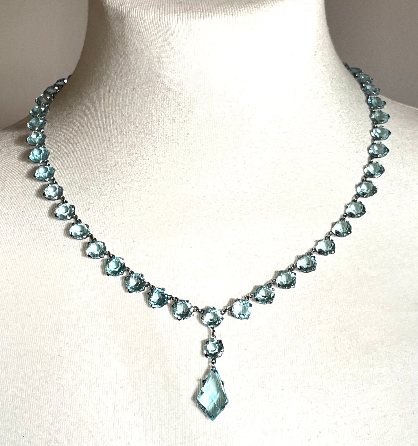 Vintage Art Deco light sapphire blue paste riviere necklace with crystal drop, bezel set open backed stones set in silver tone