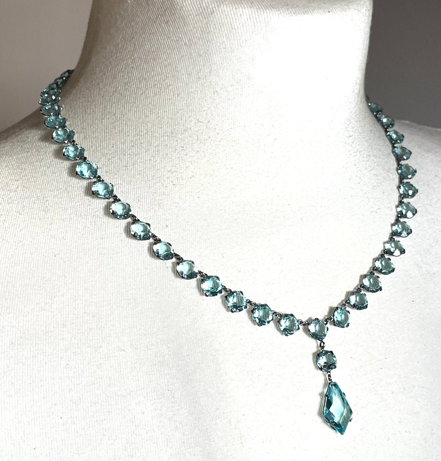 Vintage Art Deco light sapphire blue paste riviere necklace with crystal drop, bezel set open backed stones set in silver tone
