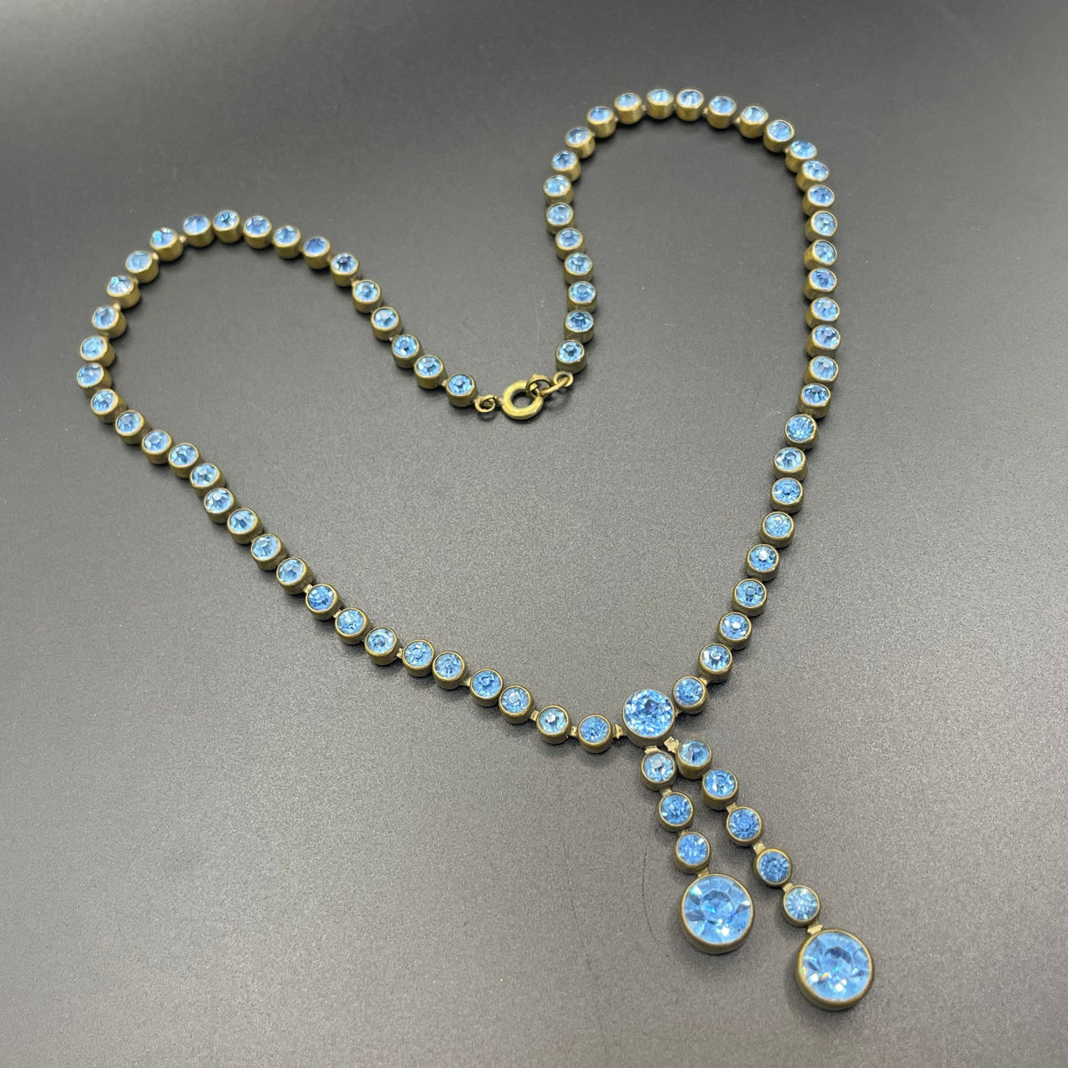 Vintage Art Deco sapphire blue paste riviere necklace with collet set rhinestones set in antique gold tone & asymmetric negligee strands