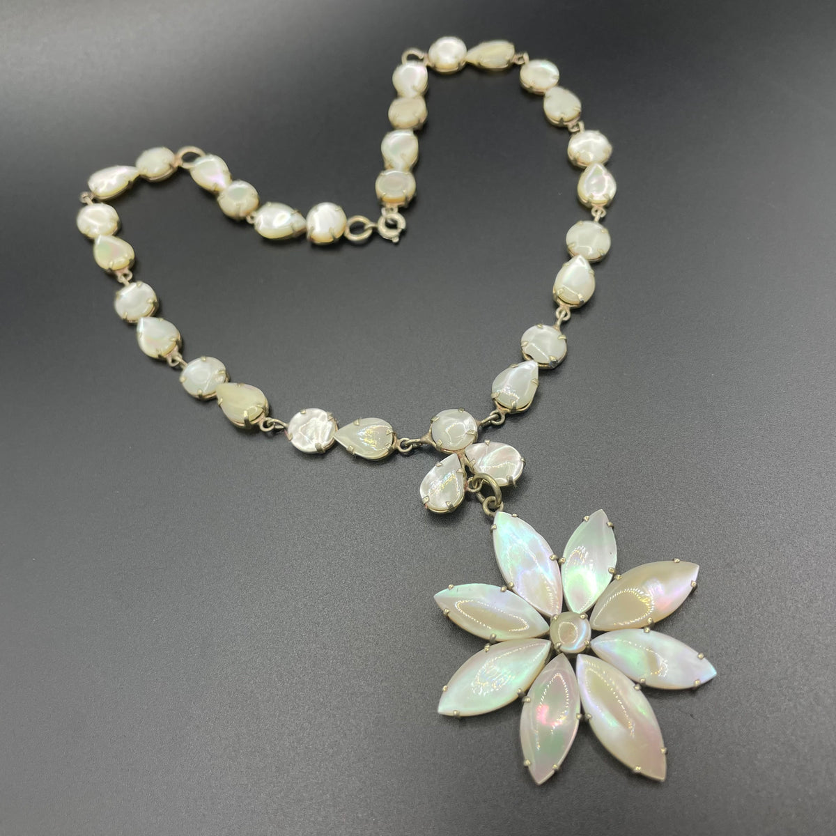 Antique / vintage mother of pearl riviere necklace, open backed pale gold tone settings, beautiful MOP cabochons, large floral pendant drop