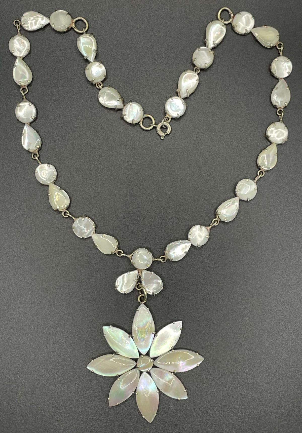 Antique / vintage mother of pearl riviere necklace, open backed pale gold tone settings, beautiful MOP cabochons, large floral pendant drop