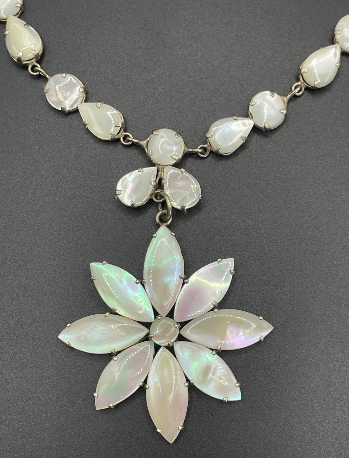 Antique / vintage mother of pearl riviere necklace, open backed pale gold tone settings, beautiful MOP cabochons, large floral pendant drop