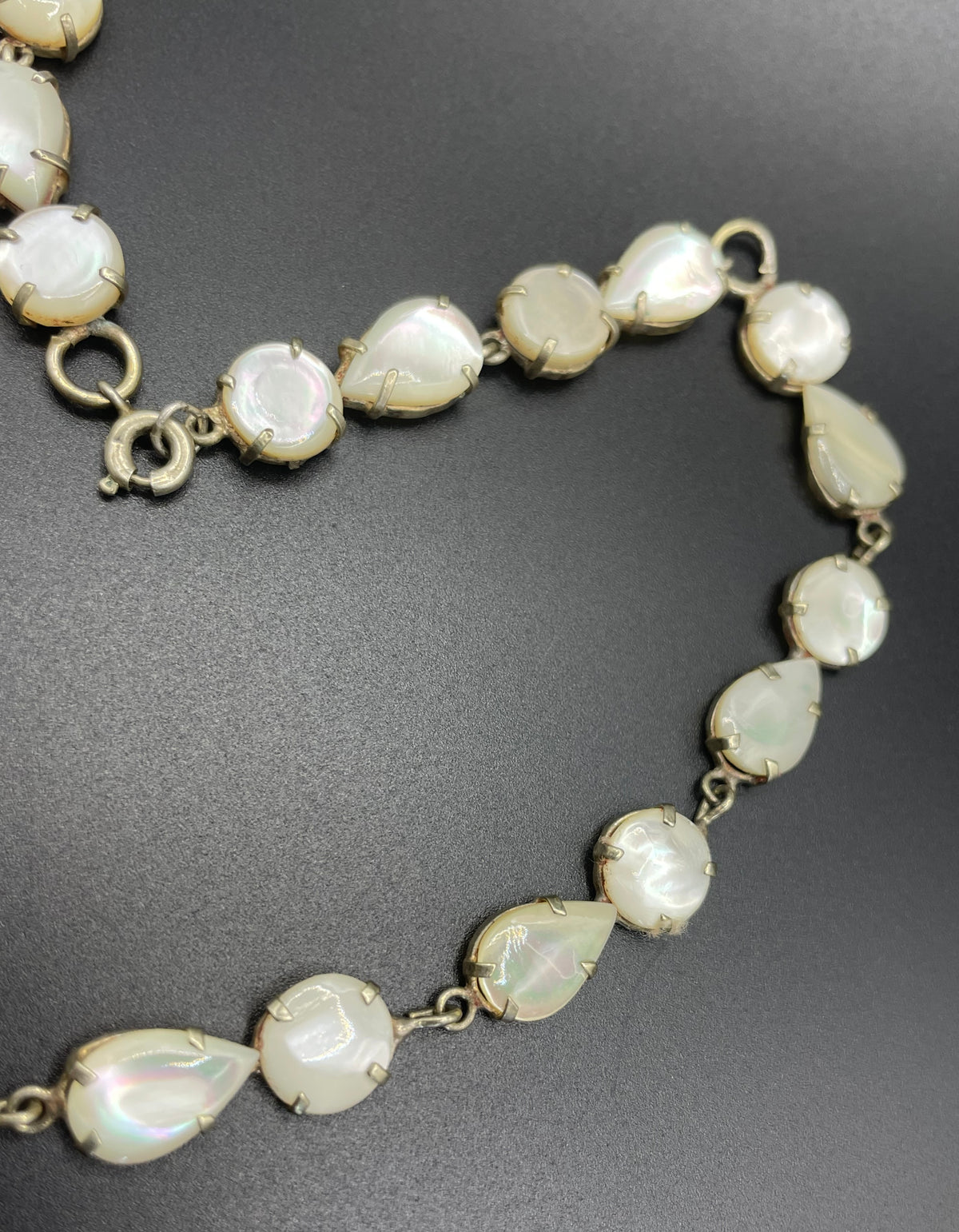 Antique / vintage mother of pearl riviere necklace, open backed pale gold tone settings, beautiful MOP cabochons, large floral pendant drop