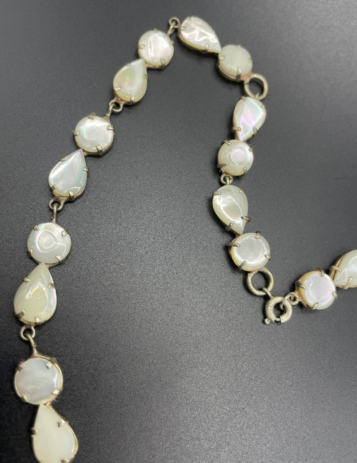 Antique / vintage mother of pearl riviere necklace, open backed pale gold tone settings, beautiful MOP cabochons, large floral pendant drop