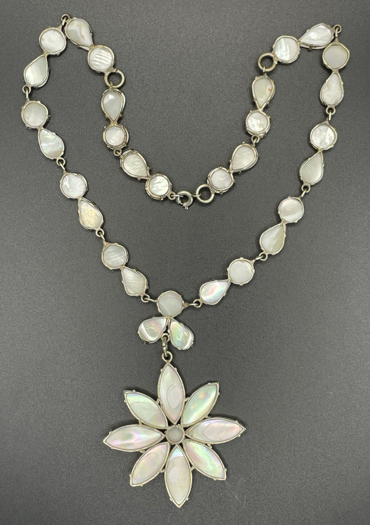 Antique / vintage mother of pearl riviere necklace, open backed pale gold tone settings, beautiful MOP cabochons, large floral pendant drop