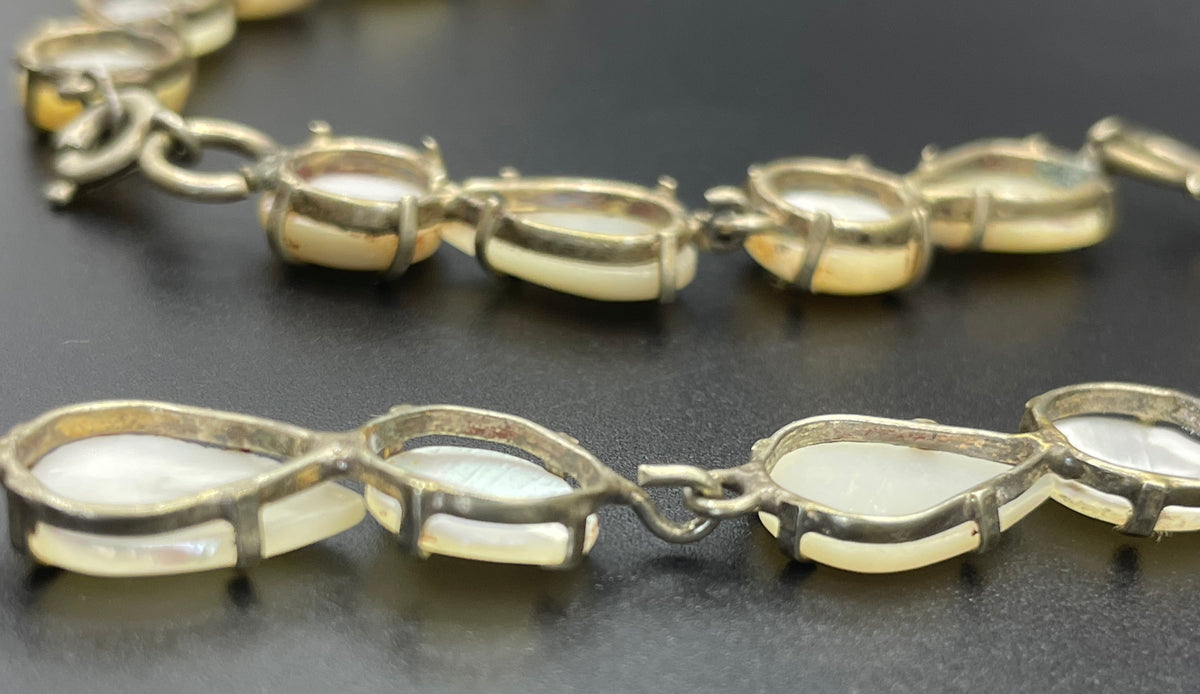 Antique / vintage mother of pearl riviere necklace, open backed pale gold tone settings, beautiful MOP cabochons, large floral pendant drop