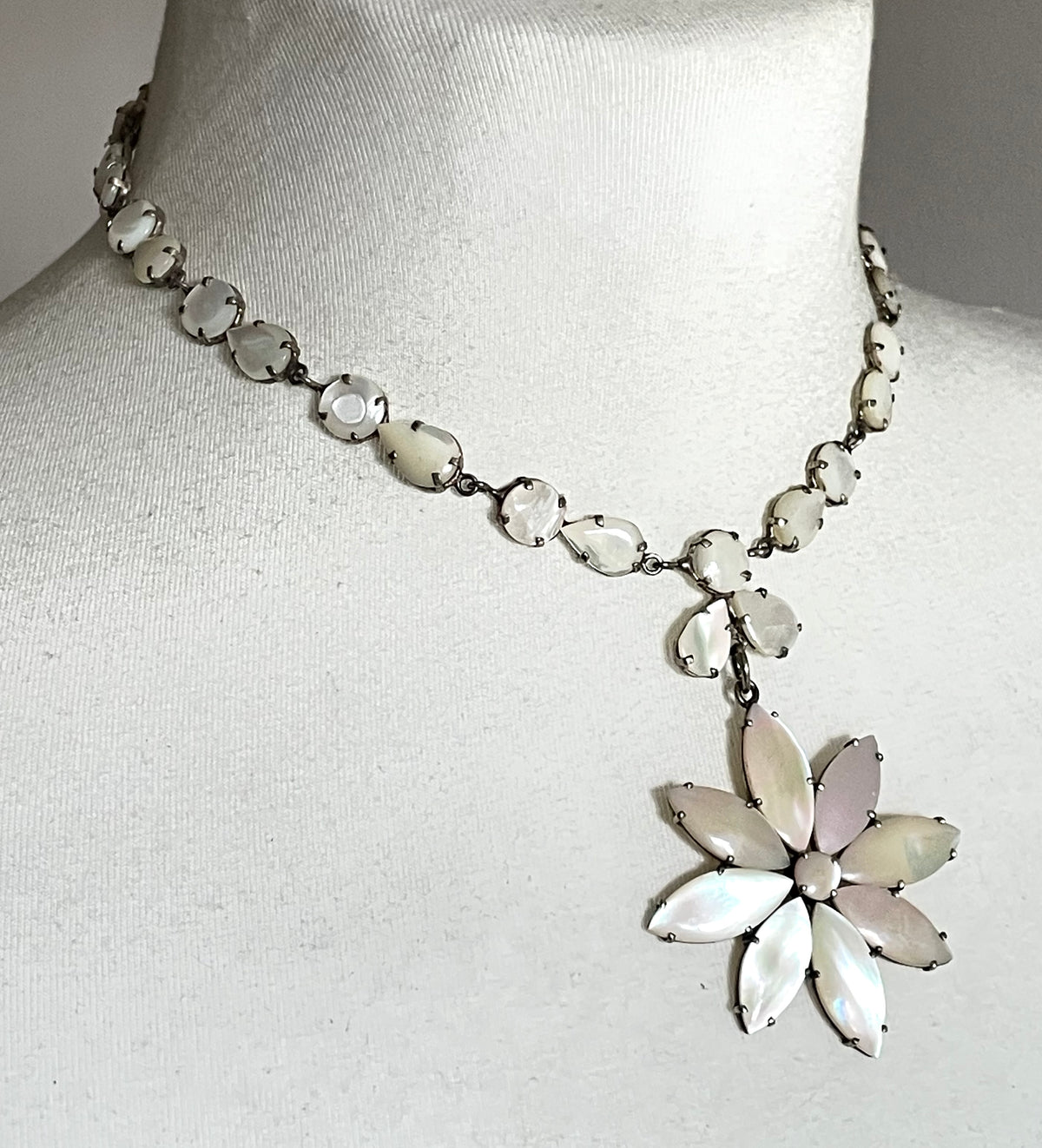 Antique / vintage mother of pearl riviere necklace, open backed pale gold tone settings, beautiful MOP cabochons, large floral pendant drop