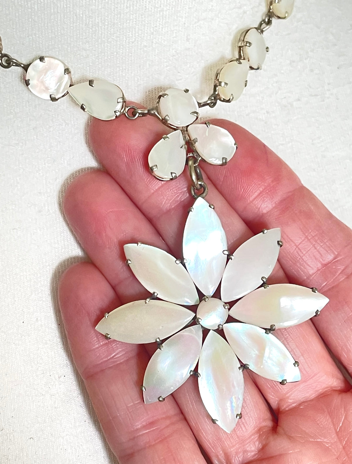 Antique / vintage mother of pearl riviere necklace, open backed pale gold tone settings, beautiful MOP cabochons, large floral pendant drop