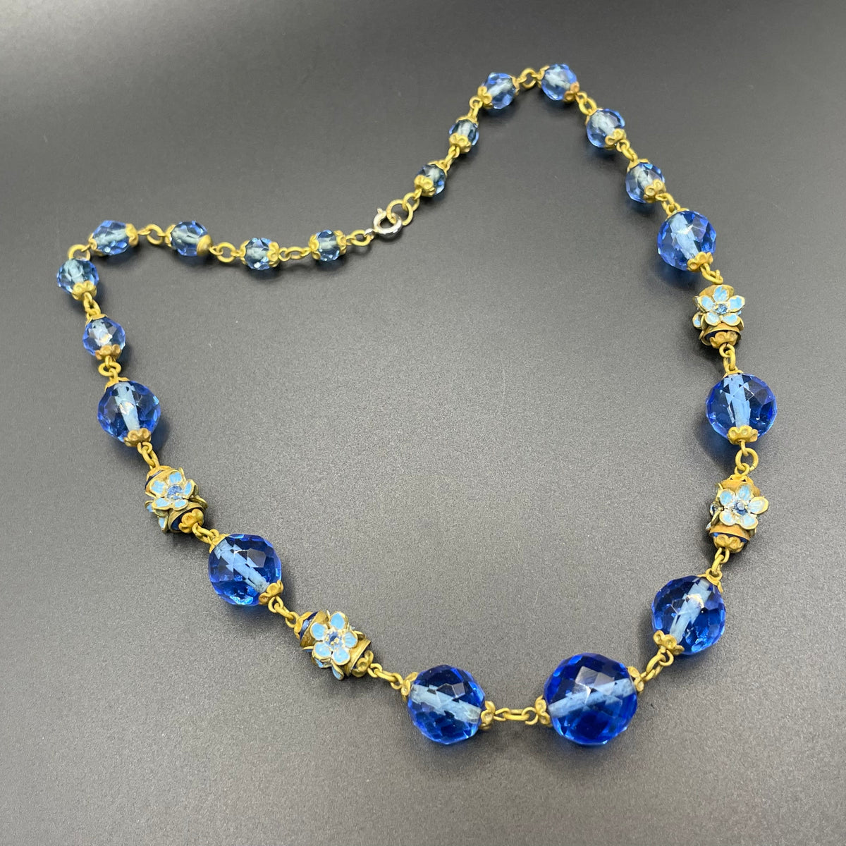 Vintage Art Deco faceted sapphire blue glass bead and rhinestone Czech necklace with beautiful gold tone and enamel painted floral features