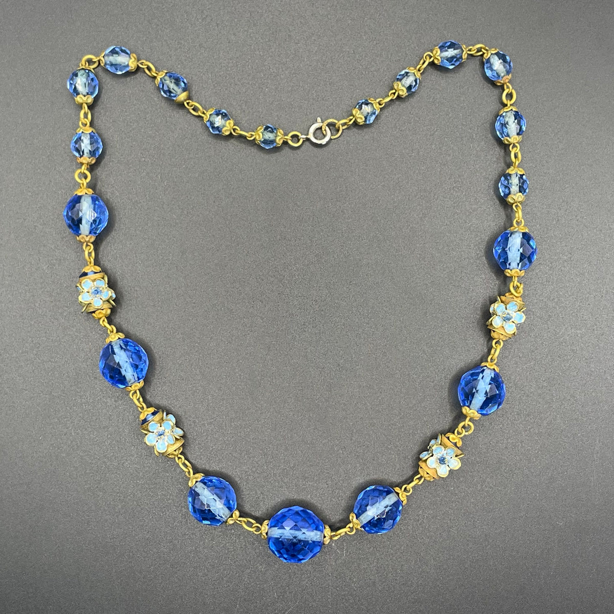 Vintage Art Deco faceted sapphire blue glass bead and rhinestone Czech necklace with beautiful gold tone and enamel painted floral features