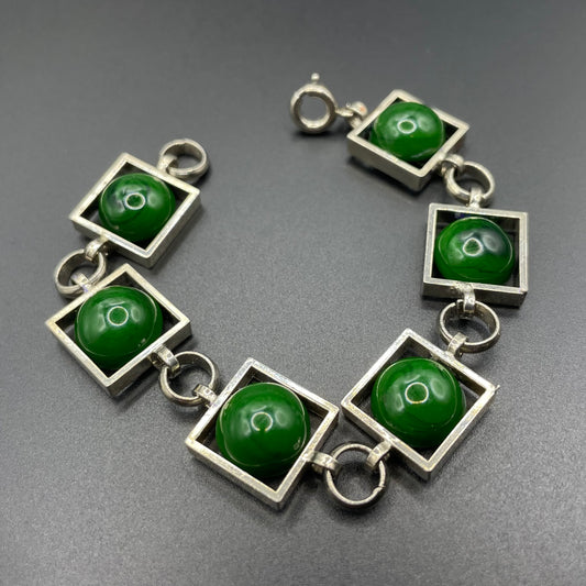 Vintage Art Deco Bauhaus machine age geometric silver tone chrome panel bracelet with glowing green banded glass cabochons, size small