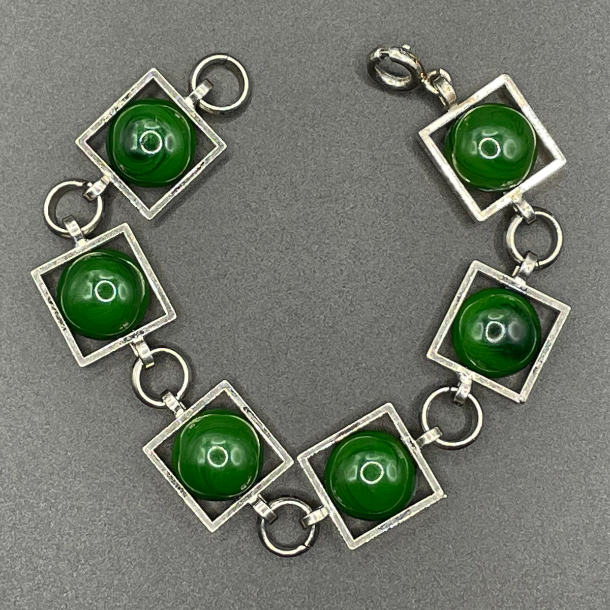 Vintage Art Deco Bauhaus machine age geometric silver tone chrome panel bracelet with glowing green banded glass cabochons, size small