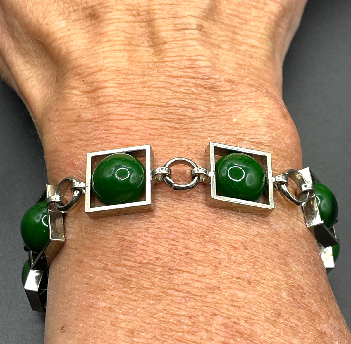 Vintage Art Deco Bauhaus machine age geometric silver tone chrome panel bracelet with glowing green banded glass cabochons, size small