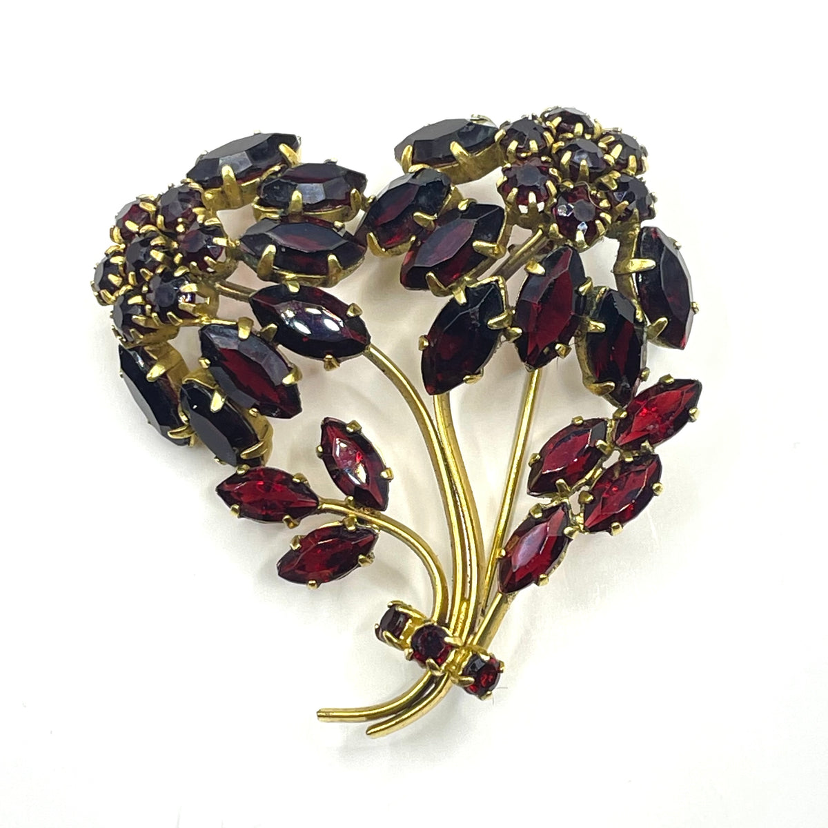 Vintage red garnet glass flower bouquet brooch, with rhinestones set open-backed in gold tone