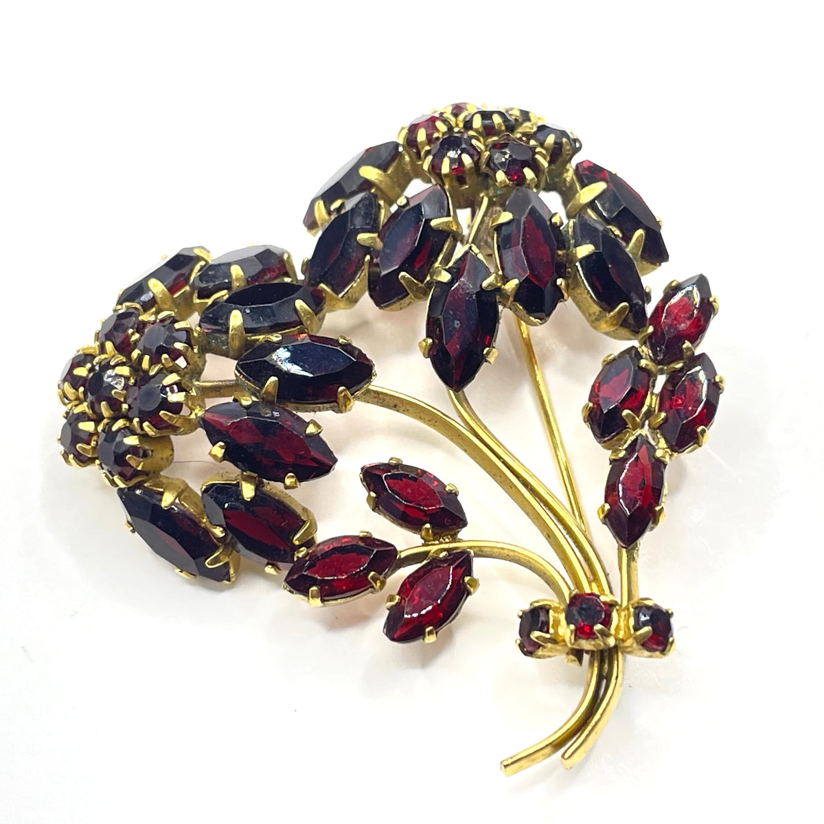 Vintage red garnet glass flower bouquet brooch, with rhinestones set open-backed in gold tone
