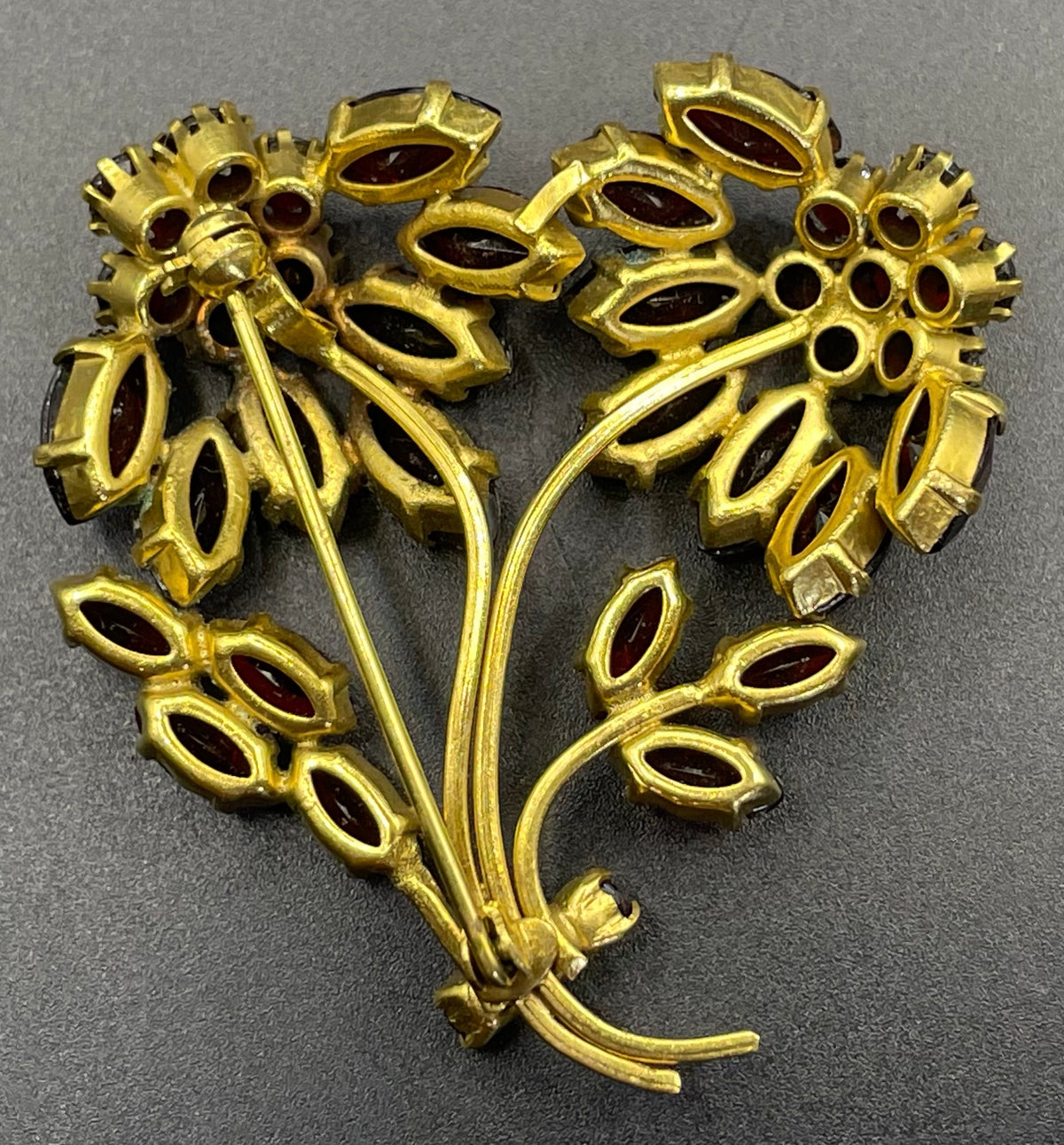 Vintage red garnet glass flower bouquet brooch, with rhinestones set open-backed in gold tone