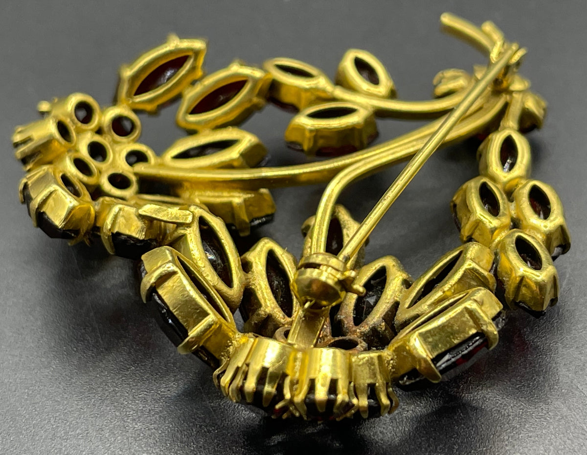 Vintage red garnet glass flower bouquet brooch, with rhinestones set open-backed in gold tone