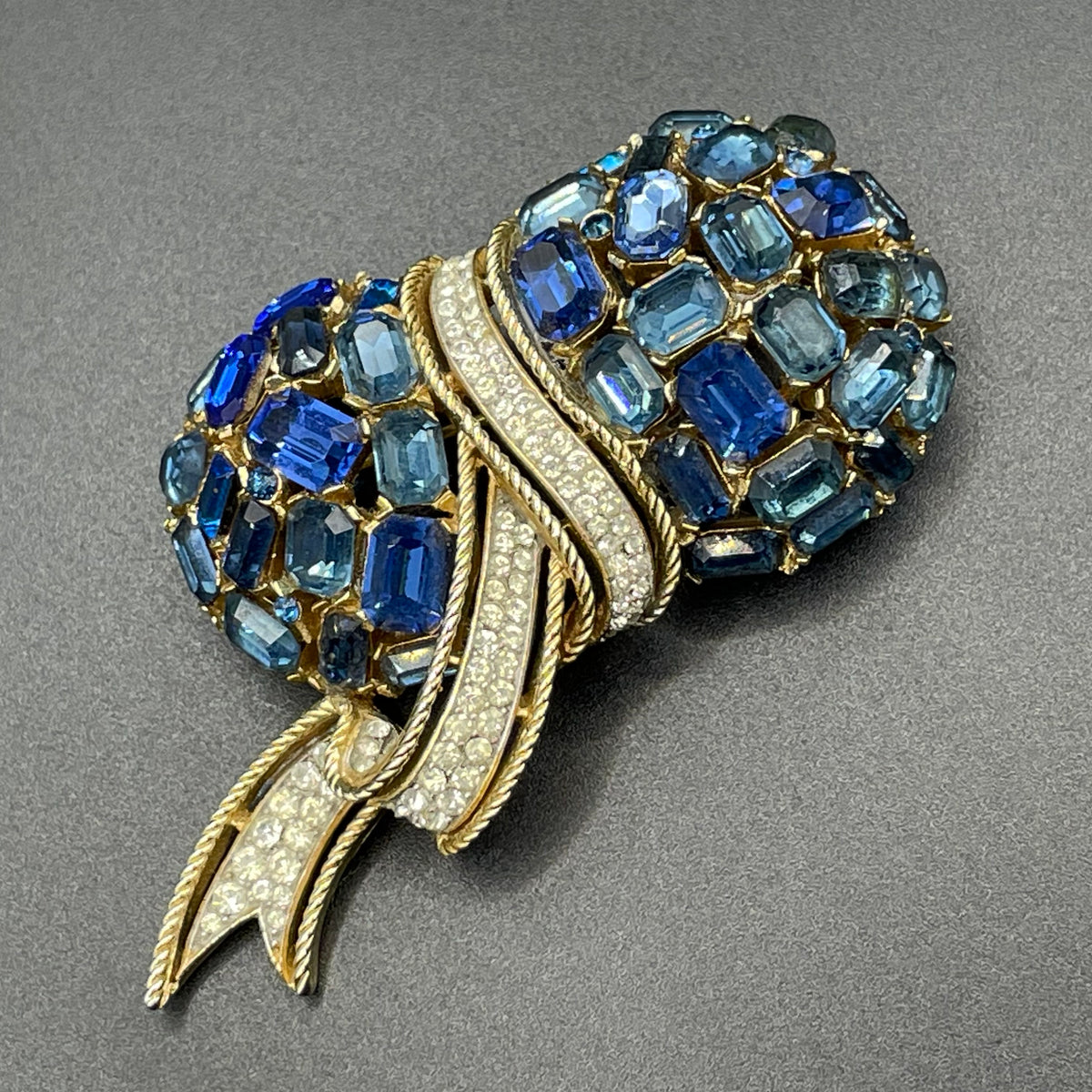 Vintage signed Trifari blue and clear rhinestone brooch in gold tone, a heavy, good quality example