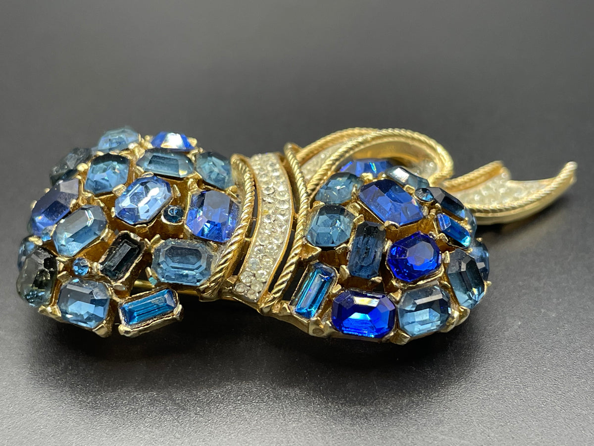 Vintage signed Trifari blue and clear rhinestone brooch in gold tone, a heavy, good quality example
