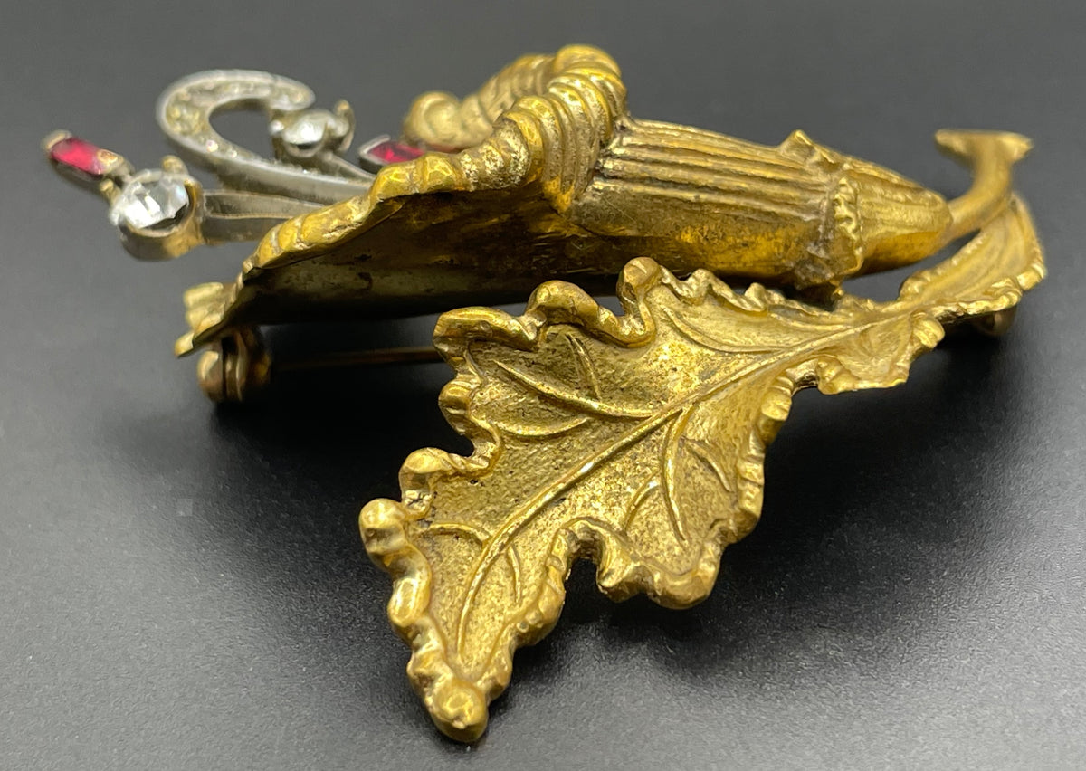 Vintage lily flower and leaf design DeRosa style brooch in gold and silver tone with clear and red rhinestones