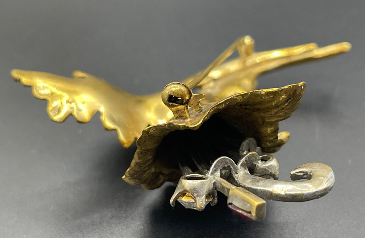 Vintage lily flower and leaf design DeRosa style brooch in gold and silver tone with clear and red rhinestones