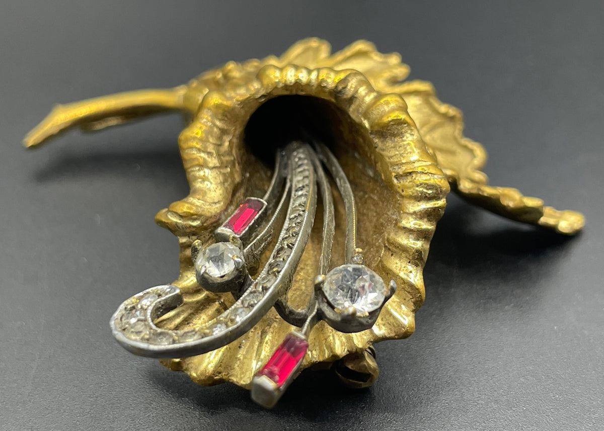 Vintage lily flower and leaf design DeRosa style brooch in gold and silver tone with clear and red rhinestones