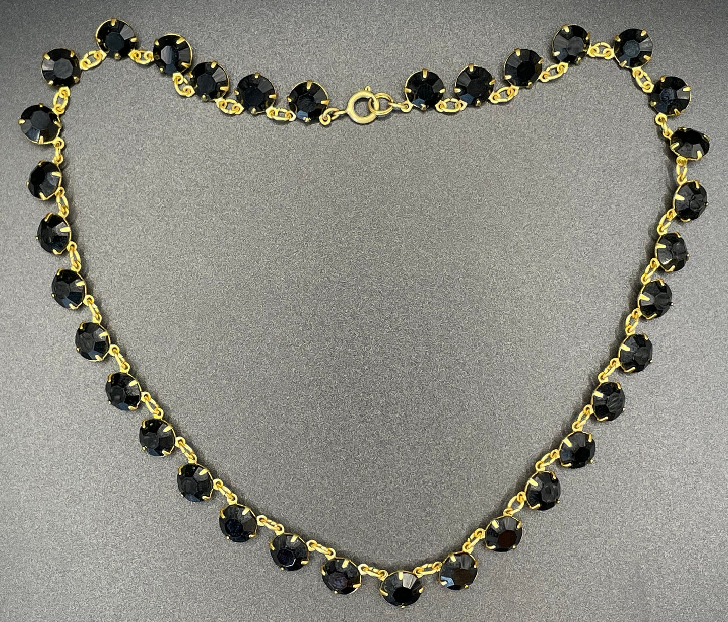 Vintage Art Deco black French jet crystal riviere necklace, single strand, bezel set, open backed rhinestones in gold tone