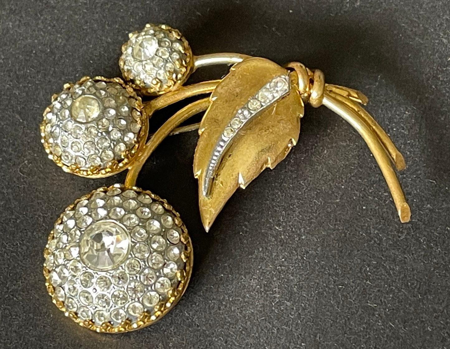 Large vintage Art Deco clear paste and gold tone floral brooch with unusual claw set rhinestone encrusted circular pieces