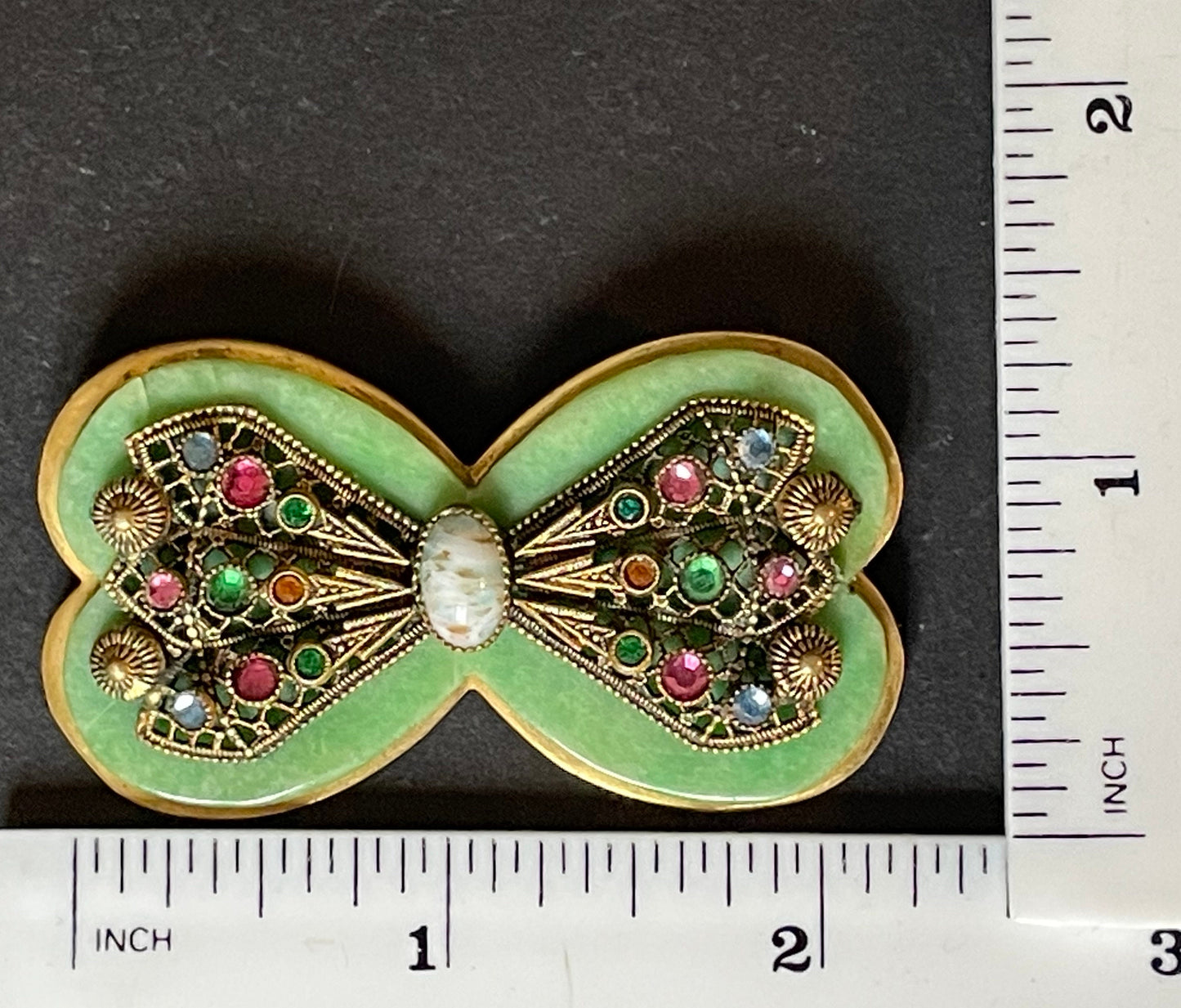 Vintage Art Deco bow shaped brooch, green galalith, gold tone with filigree and multi-coloured rhinestones Max Neiger brothers style