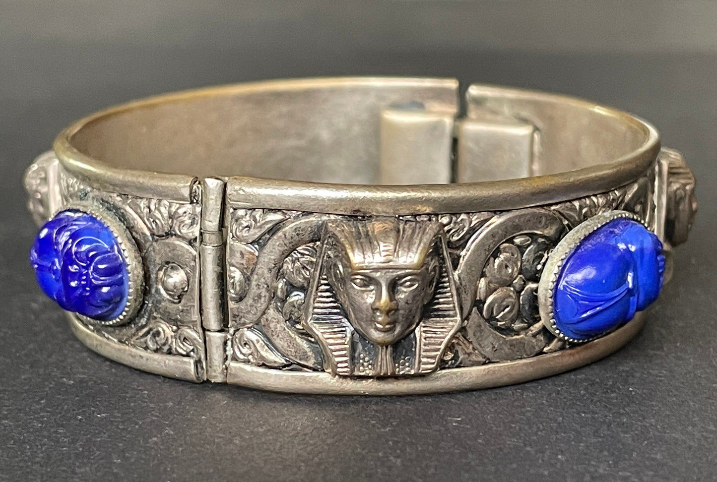 Vintage Egyptian revival Tutankhamun pharaoh and scarab beetle silver tone bangle, blue glass (faux lapis lazuli) scarab cabochons, Czech ?