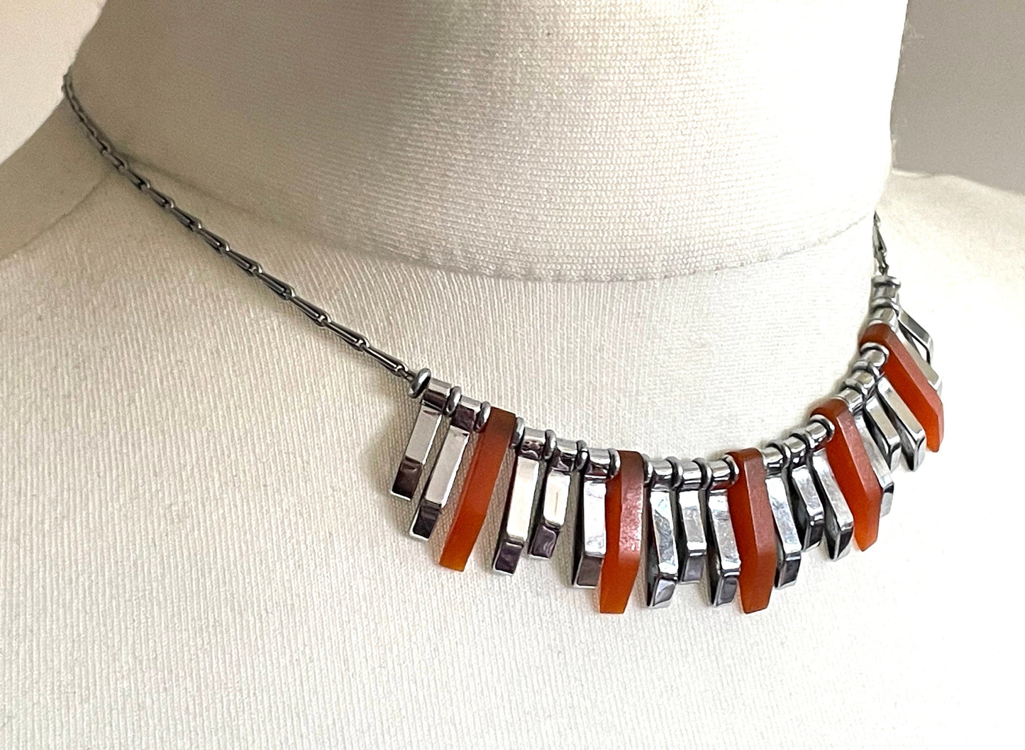 Vintage Jakob Bengel Art Deco machine age necklace, beautiful bright orange galalith 3D geometric shapes with shiny silver tone chrome