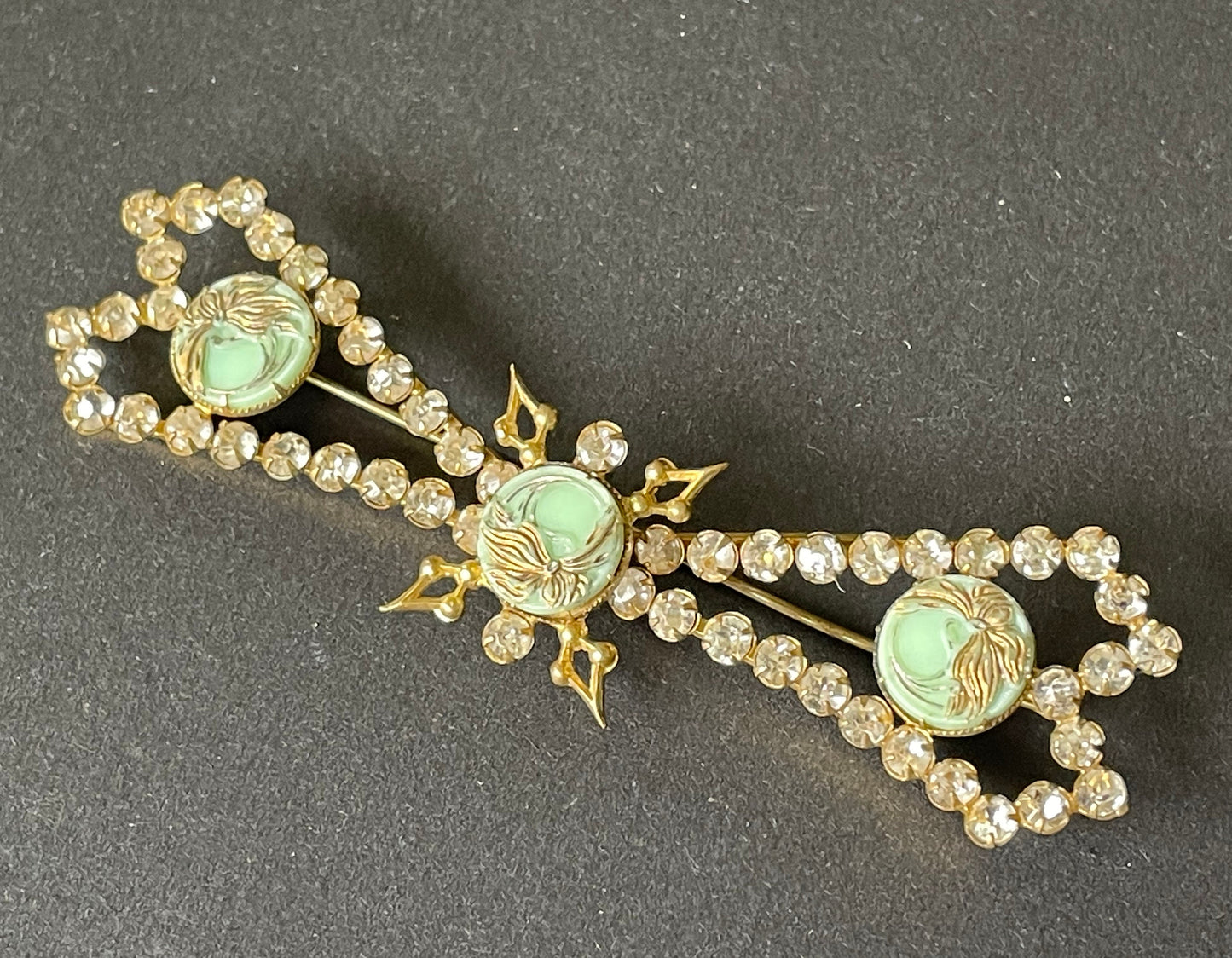 Huge vintage paste brooch, clear rhinestones with moulded green glass floral discs, gold tone closed cup settings, Deco geometric bow design