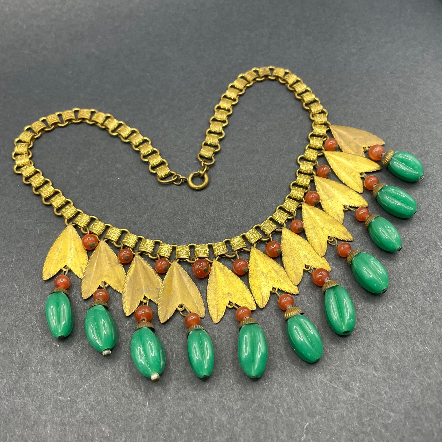 Vintage early Miriam Haskell jade green and orange poured glass beaded and gold tone Egyptian revival fringe necklace with book chain links