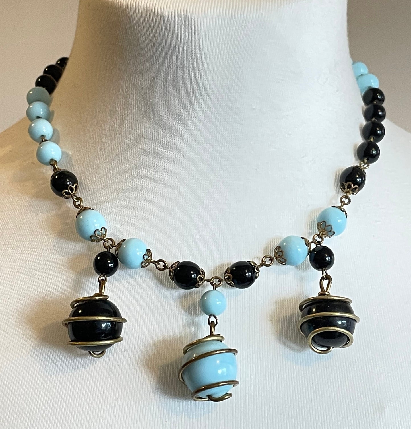 Vintage black and pale blue glass berry beaded charm necklace, gold tone wire spiral cages and filigree bead caps