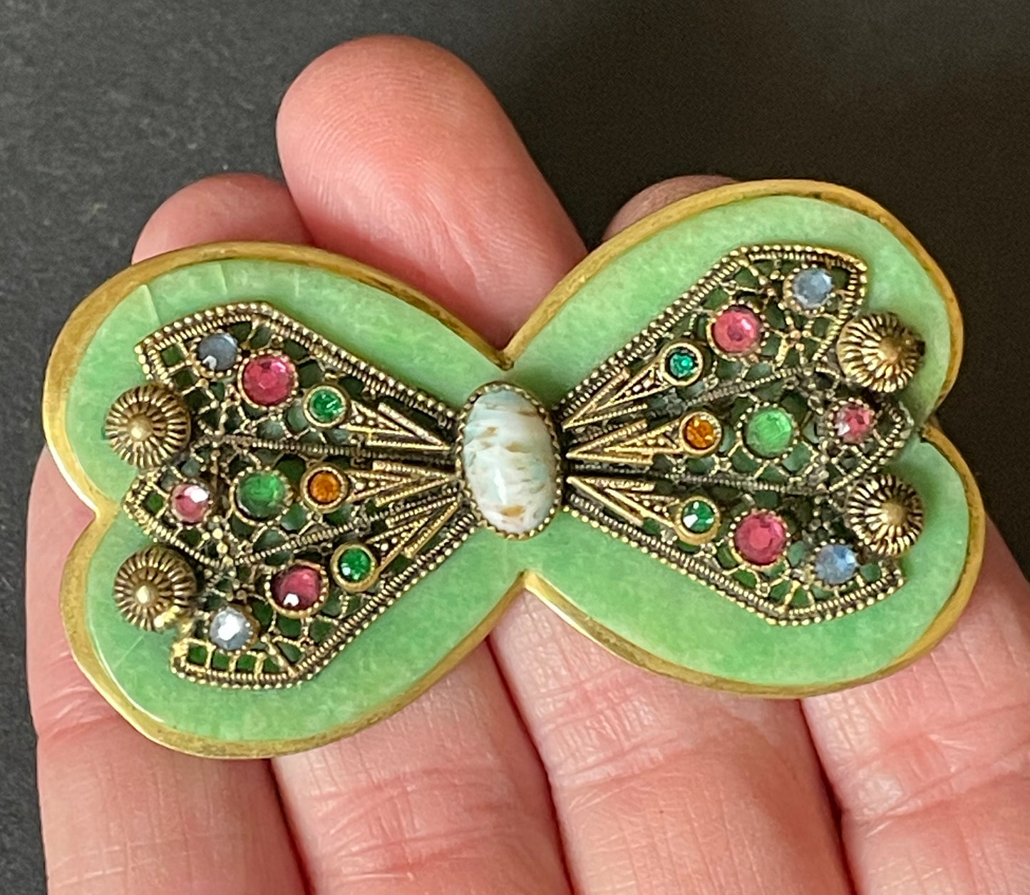 Vintage Art Deco bow shaped brooch, green galalith, gold tone with filigree and multi-coloured rhinestones Max Neiger brothers style