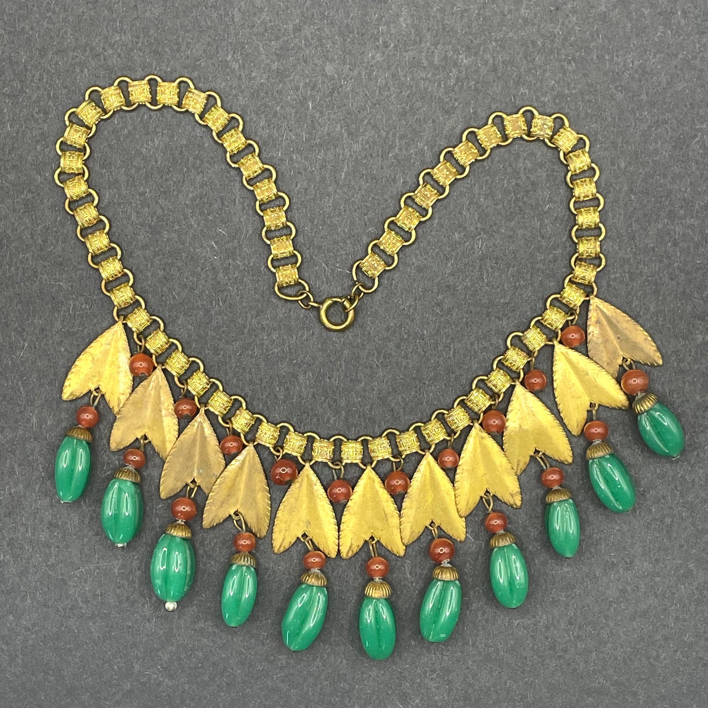 Vintage early Miriam Haskell jade green and orange poured glass beaded and gold tone Egyptian revival fringe necklace with book chain links