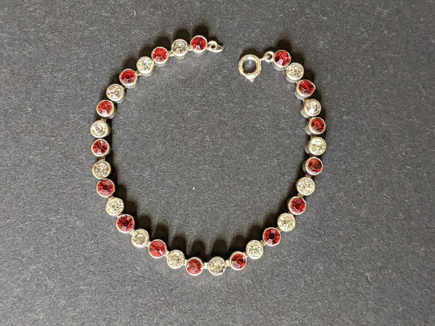 Vintage 1930s Art Deco collet set bright ruby red and clear rhinestone and silver tone tennis / cocktail bracelet