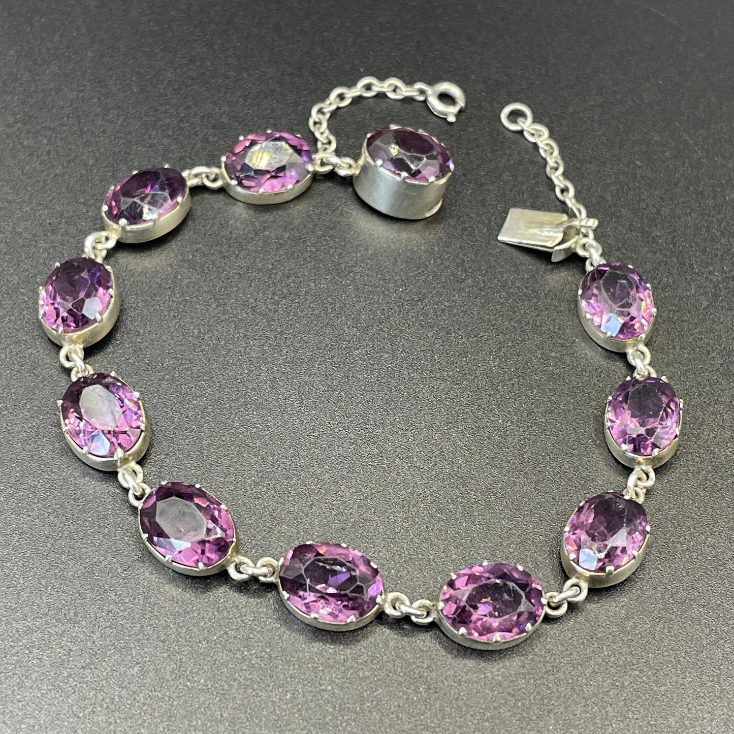 Antique fine sterling silver and amethyst paste collet set riviere style bracelet, bezel set, open backed large, oval purple stones, in box