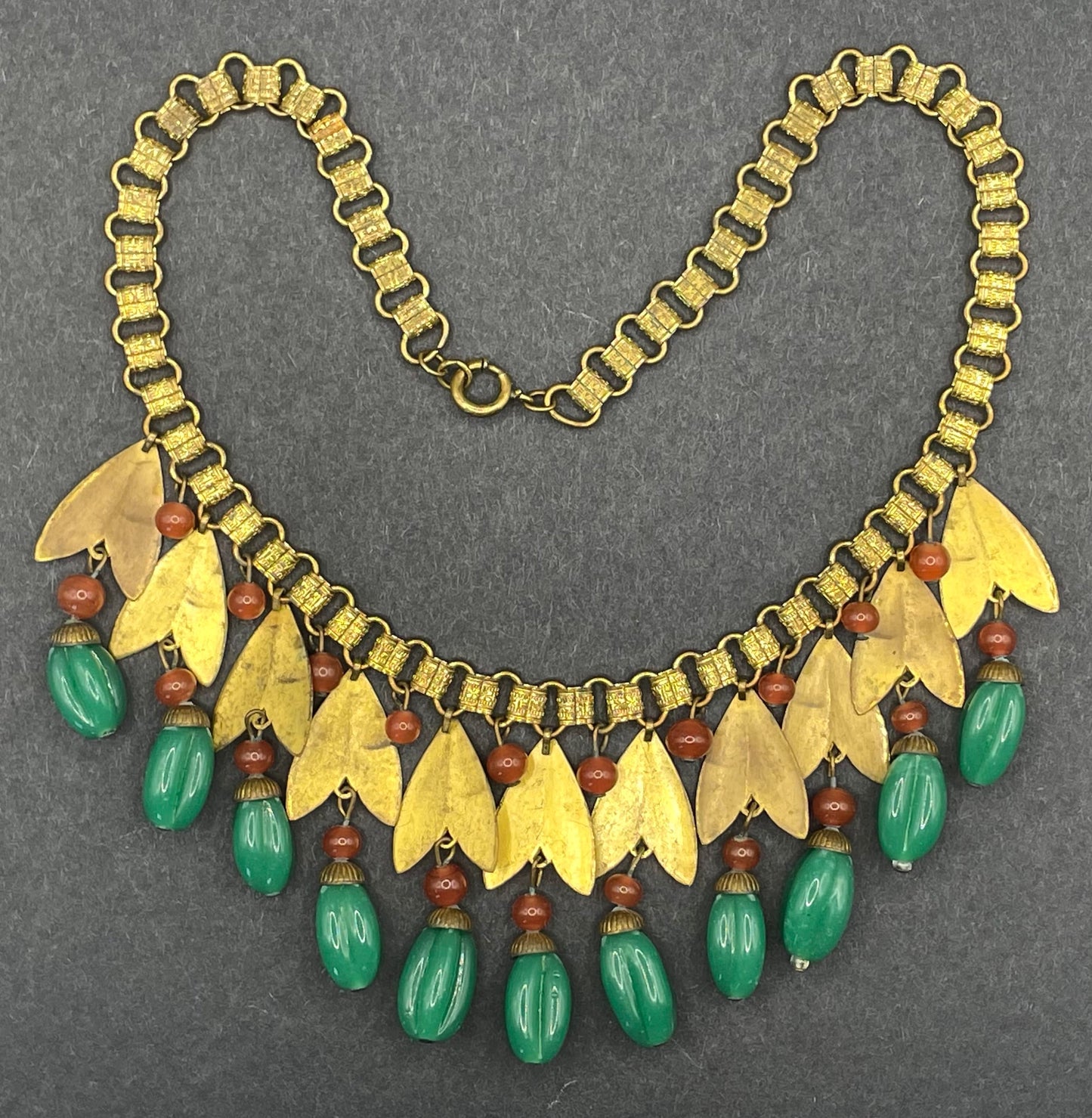 Vintage early Miriam Haskell jade green and orange poured glass beaded and gold tone Egyptian revival fringe necklace with book chain links