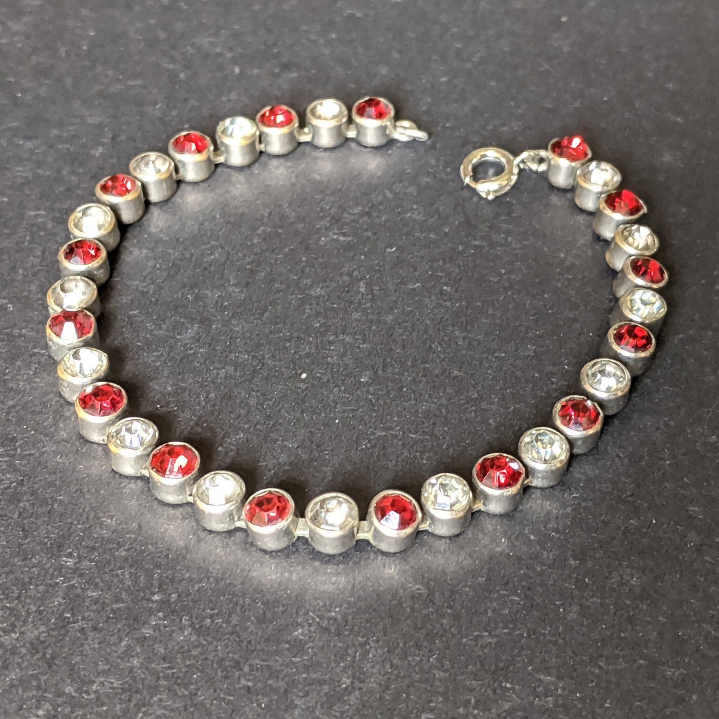 Vintage 1930s Art Deco collet set bright ruby red and clear rhinestone and silver tone tennis / cocktail bracelet