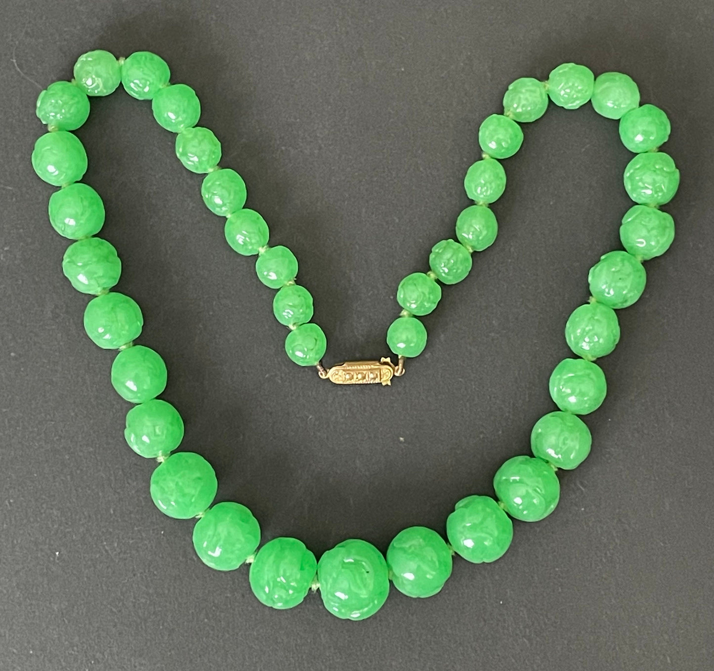 Vintage bright green jade coloured moulded glass graduated bead necklace, hand-knotted with gold tone fish hook clasp