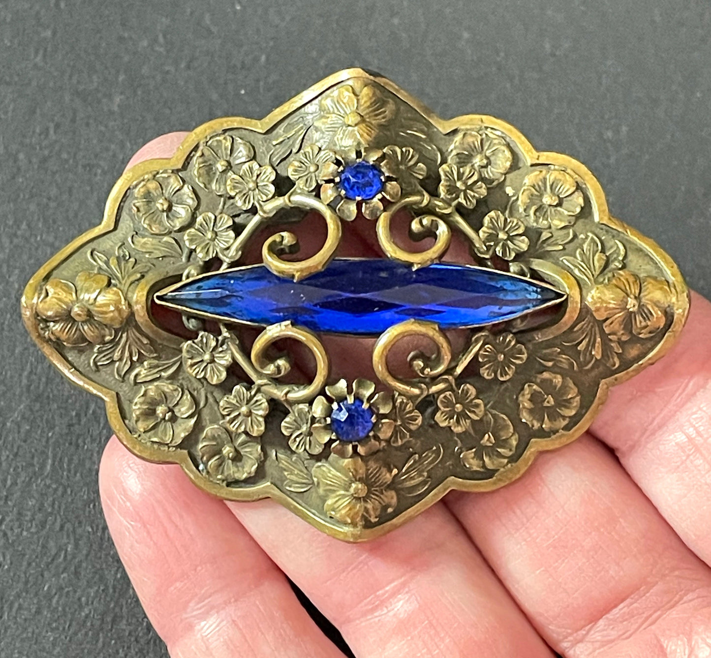 Large vintage Art Nouveau to Art Deco sapphire blue rhinestone & ornate gold tone three dimensional floral design Czech brooch, Neiger style